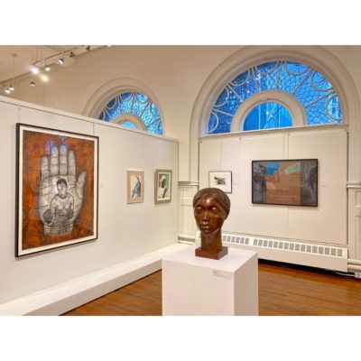 Gallery view of the "Creating Community: Cinque Gallery Artists" exhibition at Art Students League of New York. Works include, "Glory" a bust by Elizabeth Catlett, "Hand XXII" by Whitfield Lovell, two paintings by Ernest Crichlow, and others.