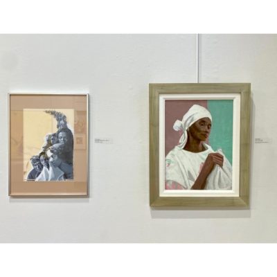 View of two works by Ernest Crichlow at the Arts Students League of New York exhibition, "Creating Community: Cinque Gallery Artists." The piece on the left is a monochromatic oil painting titled, "The Strength of Black Families" and the piece on the rights is an untitled painting of a woman in the PFF Collection.